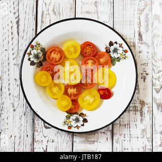 organic tomatoes, organic colorful tomatoes, colorful tomato in galvanized bowl  in rural atmosphere. colorful tomato in galvanized bowl . fresh tomat Stock Photo