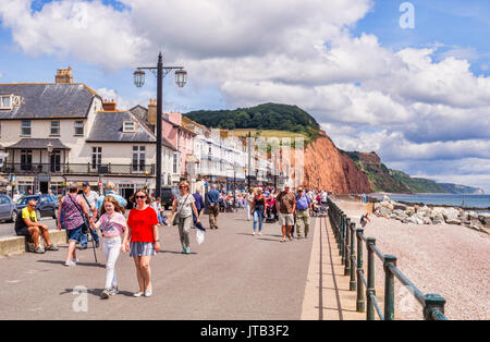 3 July 2017: Sidmouth, Dorset, England, UK - Visitors strolling on the promenade on a sunny summer day with blue sky and huge cumulus clouds. Stock Photo