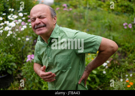 Old man having lumbago pain Stock Photo