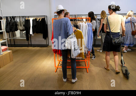 Women shopping for sale clothing inside a boutique store shop on High Street Kensington in West London, UK    KATHY DEWITT Stock Photo