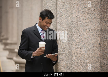 Indian business man with a tablet computer. Asian business man using digital tablet computer. Stock Photo