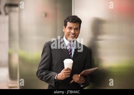 Indian business man with a tablet computer. Asian business man using digital tablet computer. Stock Photo