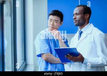 Doctors In Uniform Group of doctors in uniforms together in clinic Stock Photo - Alamy