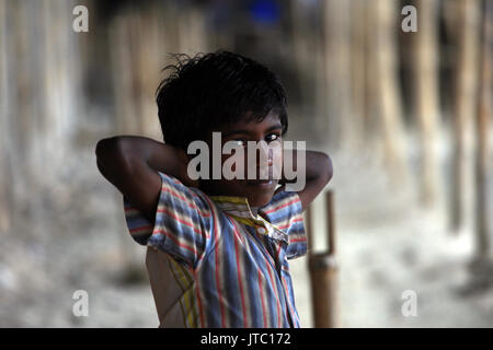 A child labour looks on in a rope manufacturing factory at Keraniganj in Dhaka on May 29, 2013. Stock Photo