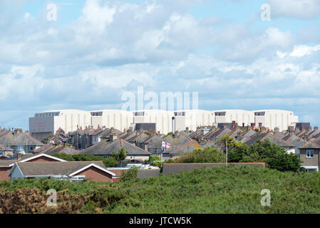 BAE Systems submarine building hangers dominate the skyline from Vickerstown on Walney Island, Barrow-in-Furness, Cumbria, UK Stock Photo