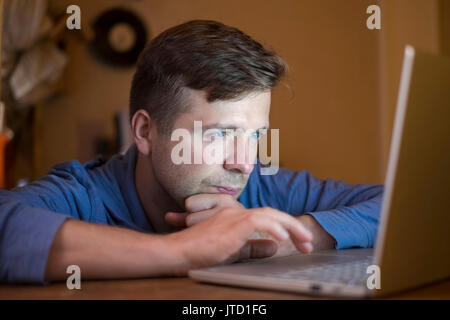 Businessman at work. Close-up top view of man working on laptop while sitting at the wooden desk Stock Photo
