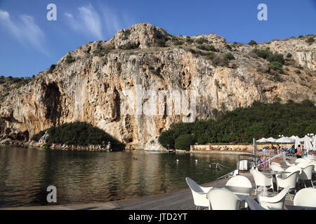 Vouliagmeni Athens Greece Tourists Swimming in Lake Vouliagmeni a Natural Spa - Was Once a Cavern But the Cave Roof Fell in Caused by Erosion from the Stock Photo