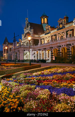 Flower garden and historic Railway Station at night, Dunedin, South Island, New Zealand Stock Photo