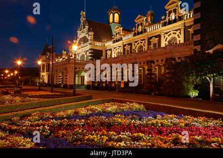 Flower garden and historic Railway Station at night, Dunedin, South Island, New Zealand Stock Photo