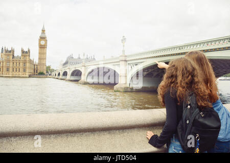 Two teenage girls look at Big Ben, London. Travel and tourism concept Stock Photo