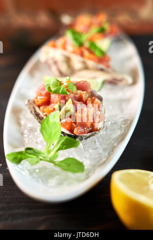 Grilled fish fillet with lemon and cherry tomatoes Stock Photo - Alamy