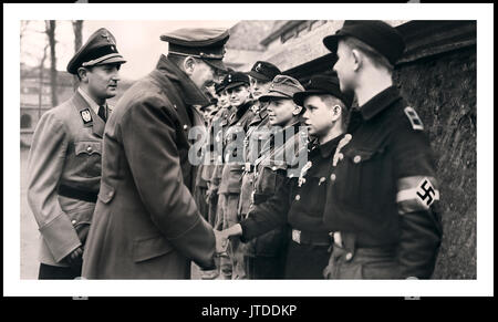 One of the last public appearances and image of Adolf Hitler meeting and awarding medals to very young teenage active fighting force Hitler Youth members April 1945 WW2 Stock Photo