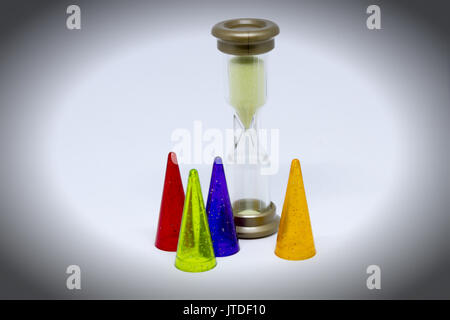 Dice and multi-colored chips on a white background Hourglass Stock Photo