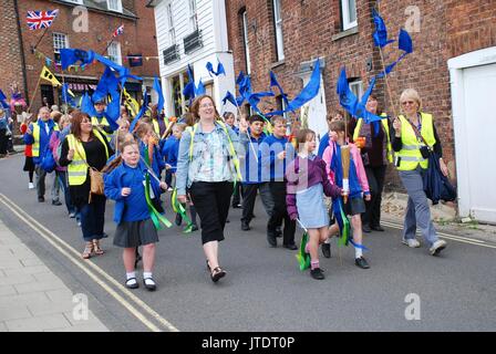People parade through the streets at an Olympic torch relay event at Rye in East Sussex, England on July 18, 2012. Stock Photo