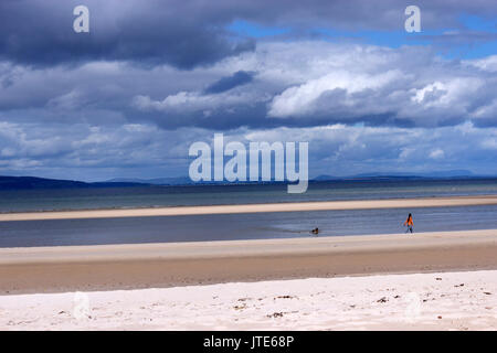 Scotland, Highlands, Nairn Beach, Dramatic Skyline, Person Walking a Dog on the Beach, Golden Sands, Shoreline, Scottish Scenery, Sea, Tide Out Stock Photo