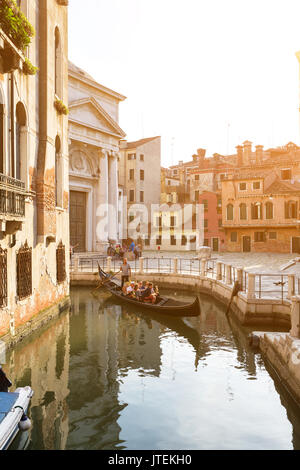 Italy, Venice - July 22, 2017: Gondola ride in small canal Stock Photo