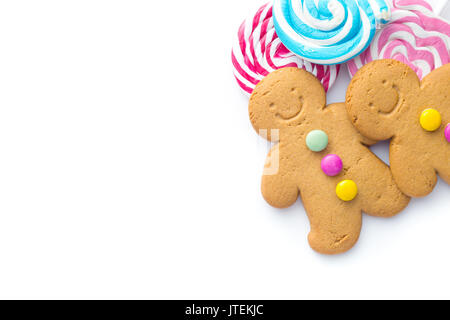 Two sweet gingerbread men and lollipops isolated on white background. Stock Photo
