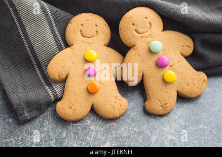 Two sweet gingerbread men on old kitchen table. Stock Photo