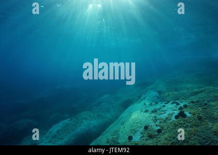 Natural sunlight underwater through water surface in the Mediterranean sea on a rocky seabed, Catalonia, Roses, Costa Brava, Spain Stock Photo