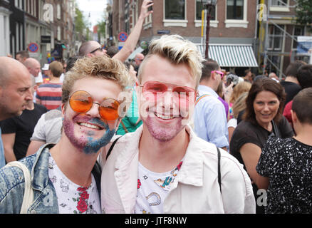 People on the street in the Prinsengracht canal participating in the Amsterdam Canal Parade during Amsterdam Gay Pride on August 5 , 2017 in Amsterdam Stock Photo