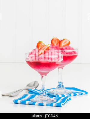 Homemade strawberry ice dessert garnished with fresh berries.  Ample copy space provided. Stock Photo