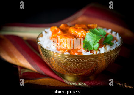 Bowl of butter chicken on a bed of basmati rice. Stock Photo