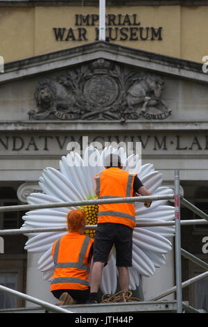 London, UK. 08th Aug, 2017. People Power: Fighting for Peace exhibition. Imperial War Museum, London, UK 8th August 2017 Two large-scale flowers will be will be temporarily placed on the 15-inch naval guns positioned in front of IWM London. Flowers were chosen as they have been a significant part of the peace movement, from the white poppy worn as a symbol of peace to the iconic image of a protester placing flowers in the barrels of rifles held by US military police at a demonstration against the Vietnam War in 1967. Credit: Jeff Gilbert/Alamy Live News Stock Photo