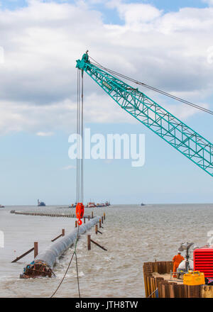 A new flood water outfall pipe has been transported by ship from Norway to the coast of Ireland and is now installed at Anchorsholme Beach, Blackpool, Lancashire. August 2017. This new extended submerged outfall pipe will discharge the excess screened stormwater out to sea and is part of improvements to the Fylde coast water management system. Filled with air to keep it afloat, the 20,000-tonne pipe left Ireland on Saturday afternoon and was pulled across the Irish Sea with an escort of 4 ships. Stock Photo