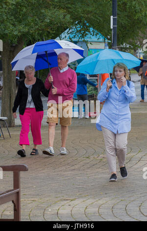 Darmouth, Devon, UK. 09th Aug, 2017. Tourists were not being put off by the heavy rain showers in Dartmouth on 9 August 2017.  Local shops were enjoying good trade as tourists headed to the shops, cafes and bars to escape the rain. Credit: James Copeland/Alamy Live News Stock Photo