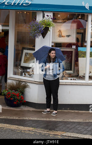 Darmouth, Devon, UK. 09th Aug, 2017. Tourists were not being put off by the heavy rain showers in Dartmouth on 9 August 2017.  Local shops were enjoying good trade as tourists headed to the shops, cafes and bars to escape the rain. Credit: James Copeland/Alamy Live News Stock Photo