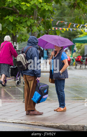 Darmouth, Devon, UK. 09th Aug, 2017. Tourists were not being put off by the heavy rain showers in Dartmouth on 9 August 2017.  Local shops were enjoying good trade as tourists headed to the shops, cafes and bars to escape the rain. Credit: James Copeland/Alamy Live News Stock Photo