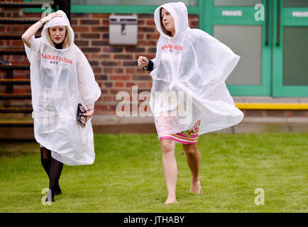 Brighton, UK. 9th Aug, 2017. Racegoers brave the rain at the Marstons Race Day in the Maronthonbet Festival of Racing at Brighton Racecourse Credit: Simon Dack/Alamy Live News Stock Photo