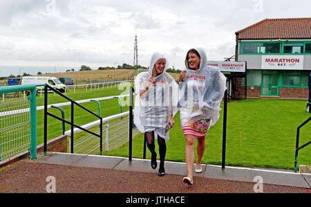 Brighton, UK. 9th Aug, 2017. Racegoers brave the rain at the Marstons Race Day in the Maronthonbet Festival of Racing at Brighton Racecourse Credit: Simon Dack/Alamy Live News Stock Photo