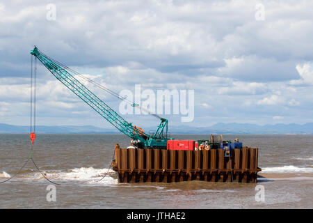 A new flood water outfall pipe has been transported by ship from Norway to the coast of Ireland and is now installed at Anchorsholme Beach, Blackpool, Lancashire. August 2017. This new extended submerged outfall pipe will discharge the excess screened stormwater out to sea and is part of improvements to the Fylde coast water management system. Filled with air to keep it afloat, the 20,000-tonne pipe left Ireland on Saturday afternoon and was pulled across the Irish Sea with an escort of 4 ships. Stock Photo