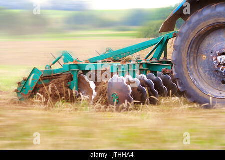 Tractor ploughing the field. Motion blur was done for effect to emphasize speed Stock Photo