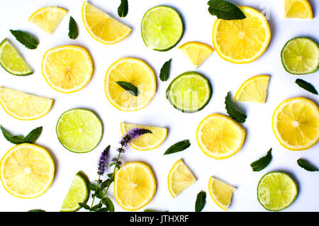 Lemon and lime slices with mint leaves on white background Stock Photo