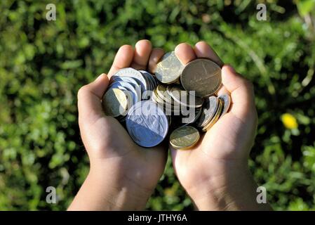 Two hands full of coins. Australian coins in kids hands Stock Photo