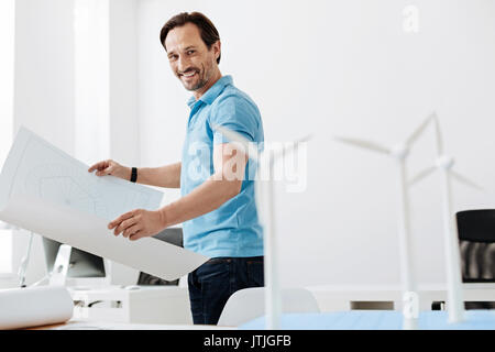 Handsome young engineer checking out wind turbine models Stock Photo