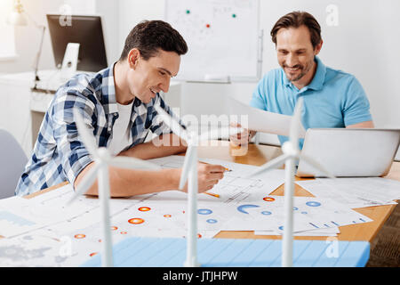 Two engineers being happy to find a mistake in calculations Stock Photo
