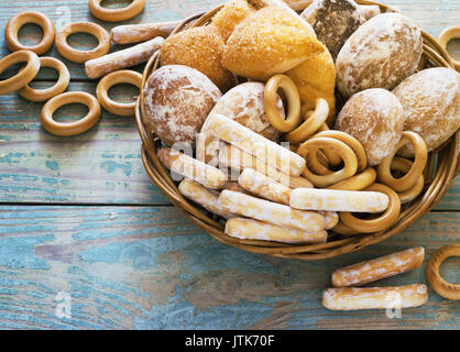 Homemade pastries biscuits, gingerbread in  wicker basket on blue wooden table Stock Photo