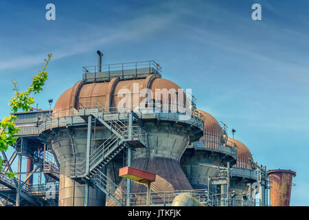 General view of an industrial plant refinery, consisting of pipes and towers of heavy industry. Stock Photo