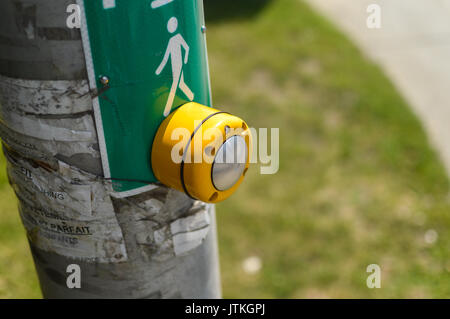 Montreal, Canada - August 8, 2017: Yellow Button of the mechanism lights traffic lights on the street in Montreal, Canada Stock Photo