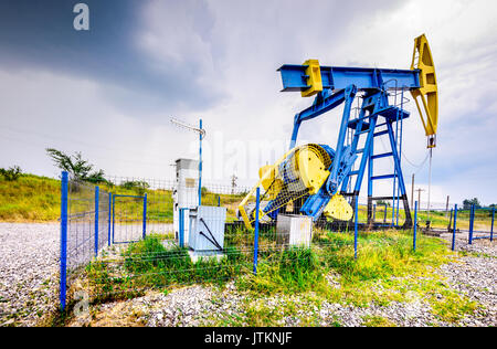 Extraction oil pumps with electrical PLC cabinet. Oil and gas industry landscape. Stock Photo