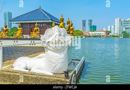 The statue of white lion guards the entrance to the Seema Malaka Temple on Beira lake, Colombo, Sri Lanka. Stock Photo