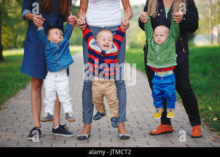 mothers holding sons by hand Stock Photo