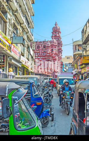 COLOMBO, SRI LANKA - DECEMBER 7, 2016: The heavy traffic in the narrow street of Pettah market with the scenic building of Jami-Ul-Alfar Mosque (Red M Stock Photo