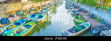 NEGOMBO, SRI LANKA - DECEMBER 7, 2016: The numerous fishing boats on Hmilton's Canal with nets on the banks, on December 7 in Negombo. Stock Photo