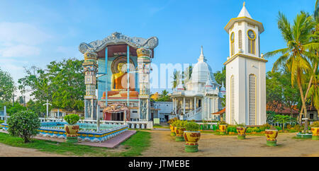 The Angurukaramulla Buddhist Temple (Bodhirajaramaya) in Negombo with scenic buildings and statue of Lord Buddha in richly decorated niche with the Dr Stock Photo