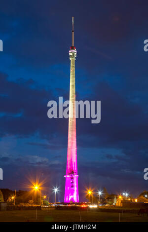 Emley Moor transmission station near Huddersfield at night illuminated in different colours during the start of the Tour de France event Stock Photo