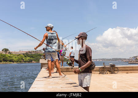 Cuban fishermen angling on the Malecon sesaside promenade in Old Havana, Cuba Stock Photo